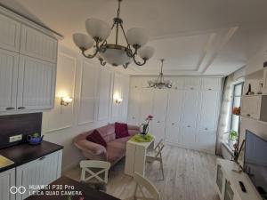 a living room with a couch and a table at Luxury Apartments Alix in Burgas
