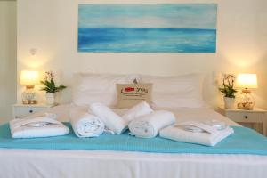 a pile of towels are arranged on a bed at Georgia Villas in Skiathos