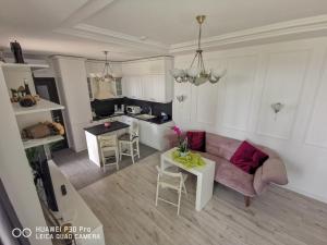 a living room with a couch and a table at Luxury Apartments Alix in Burgas City