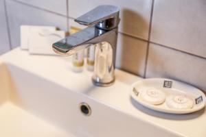 a sink with a faucet and a plate on it at Georgia Villas in Skiathos
