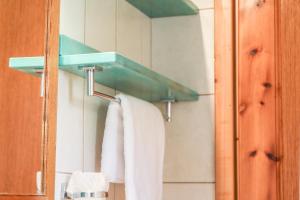 a bathroom with a towel rack and a mirror at Georgia Villas in Skiathos