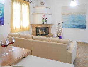 a living room with a couch and a fireplace at Georgia Villas in Skiathos