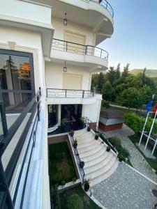 a building with stairs and a balcony at Garden Boutique Hotel in Elbasan