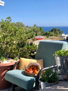 a basket of fruit sitting on a chair on a patio at Apartments Coco in Hvar +10 photos
