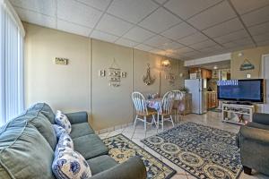 a living room with a couch and a table at Condo with Pool Access on Wildwood Crest Beach! in Wildwood Crest