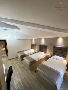 Postel nebo postele na pokoji v ubytování Hotel Holiday