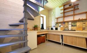 a kitchen with a spiral staircase in the middle at Marychost- dom do wynajęcia in Kazimierz Dolny