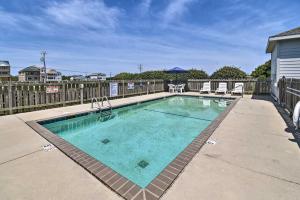 a swimming pool in the middle of a yard at Beachfront Nags Head Condo with Private Balcony! in Nags Head
