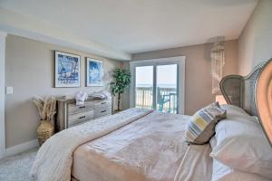 a bedroom with a bed with a view of the ocean at Beachfront Nags Head Condo with Private Balcony! in Nags Head