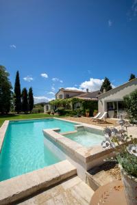 a swimming pool in the backyard of a house at Mas Coeur de Provence Calme Luxe Grand Parc in Pernes-les-Fontaines