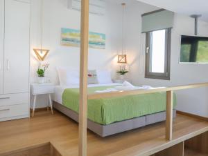 a bedroom with a bed and a desk in a room at Georgia Villas in Skiathos
