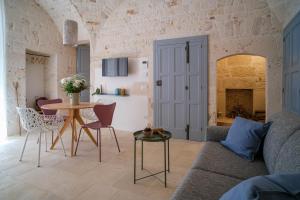 a living room with a couch and a table at Continuum 28 in Castellana Grotte