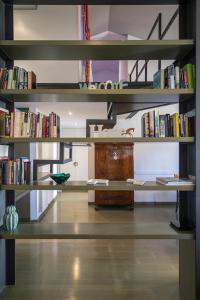 a room with shelves filled with books at MANSARDINA - 1 min from Accademia - duplex stylish and cosy in Venice