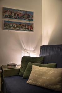 a couch in a living room with a picture on the wall at MANSARDINA - 1 min from Accademia - duplex stylish and cosy in Venice