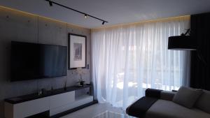 a living room with a couch and a large window at Appartement Villa Cassis in Cassis