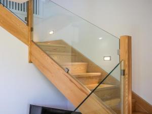 a staircase in a house with glass railing at Georgia Villas in Skiathos