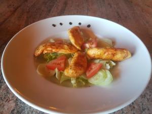 a white bowl of food with chicken legs and vegetables at Room in Rakovica with WiFi 4958-3 in Rakovica +15 photos