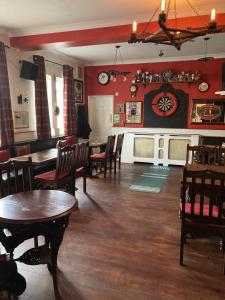 a living room with tables and chairs and a dining room at The Star Inn in Nafferton