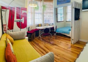 a living room with a couch and a table at Two Top Central Unique Artisan Beach Studios - also separate spa cabin in Brighton & Hove