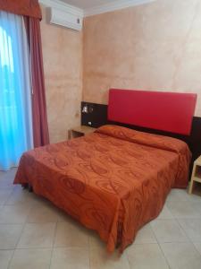 a bedroom with a bed with a red bedspread at Oasi Del Visir Resort in San Vito dei Normanni +40 photos