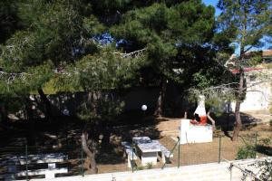 a park with a bench and a table and trees at Casa Vacanze Ramo in Mazara del Vallo