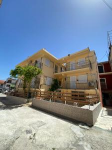 a large building with a fence in front of it at Avra Boutique in Benitses +28 photos