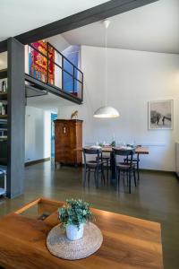 a living room with a table and a dining room at MANSARDINA - 1 min from Accademia - duplex stylish and cosy in Venice