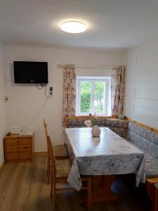 a living room with a table and a couch at Ferienhaus-Loidl in Bad Ischl