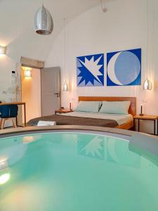 a hotel room with a bed and a swimming pool at Continuum 28 in Castellana Grotte