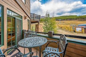a patio with a table and chairs on a balcony at Crystal Peak Pioneer in Breckenridge
