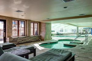 a large room with a swimming pool in a building at Crystal Peak Pioneer in Breckenridge