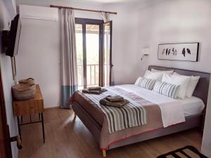 
a bed in a bedroom with a white bedspread at Villa Karina in Kolios
