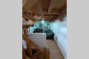 an attic room with wooden ceilings and a white wall at Casa Arangol in Pedruel