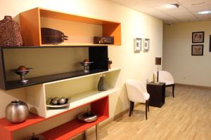 a room with shelves with vases and a table and chairs at Hostal San Isidro in Autol