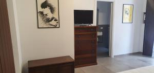 a living room with a dresser and a television at da matilda 2 in Agrigento