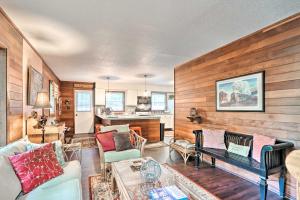 a living room with wooden walls and a couch and a table at Relaxing Eagle Rock Resort Home - 1 Block to Lake! in Hazleton