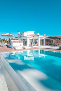 a villa with a swimming pool in front of a house at FINCA YANTAR in Motril