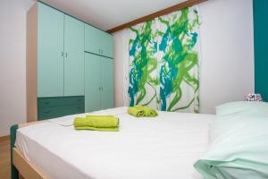 sypialnia z łóżkiem z zielonym ręcznikiem w obiekcie Apartment in Njivice with Seaview, Balcony, Air condition, WIFI (4687-2) w mieście Nijvice
