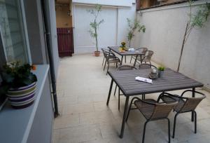 two tables and chairs in a room with plants at Vila 27 in Eforie Nord +42 photos