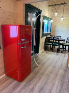 a red refrigerator in a room with a table at mySeenland in Senftenberg