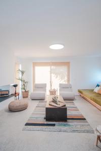 a living room with two chairs and a table at FINCA YANTAR in Motril +41 photos