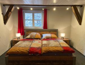 a bedroom with a bed with two lamps and a window at Appartement Schlossberg, Gasthaus Hirsch in Hirschhorn