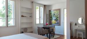 a bedroom with a table and a room with a bed at Villa Angelus in Nice