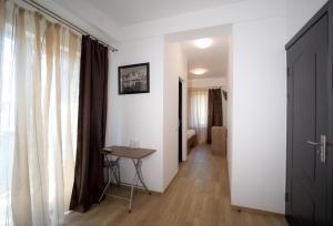 a room with a hallway with a table and a window at Vila 27 in Eforie Nord