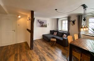 a living room with a couch and a table at Appartement Schlossberg, Gasthaus Hirsch in Hirschhorn