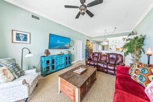a living room with a couch and a table at Windemere Beachfront Condo 1503 in Perdido Key