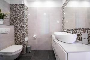 a white bathroom with a sink and a toilet at Villa Aida in Komiža +10 photos