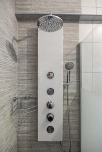a shower with a shower head in a bathroom at Casa Nikolina in Albufeira