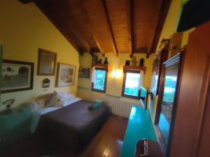 a bedroom with a bed and a couch in it at Casa Rous in Molló