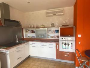 a kitchen with a stove and a microwave at Chez Marilou in Saint-Dizier
